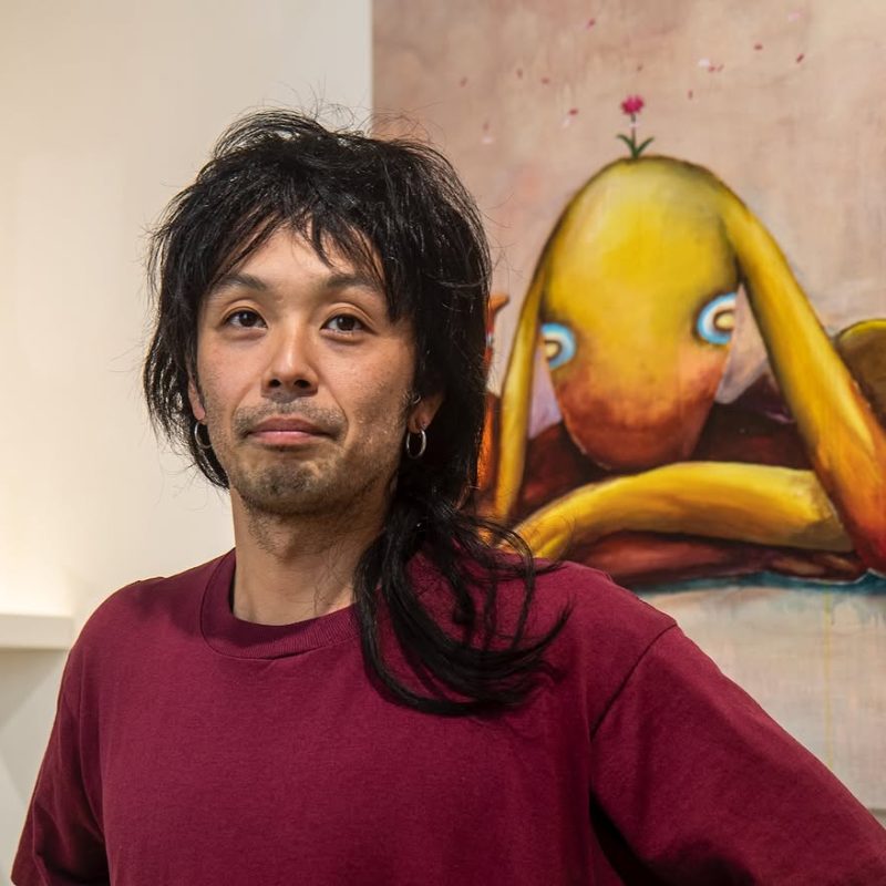 Portrait of the artist Daijiro Hama in front of one of his paintings