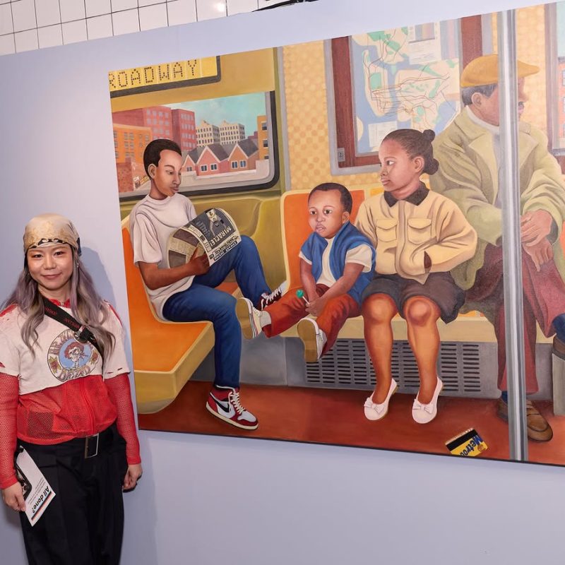 Portrait of the artist Mayumi Nakao beside one of her paintings