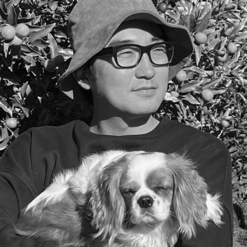 Portrait of the artist Nigamushi holding a dog