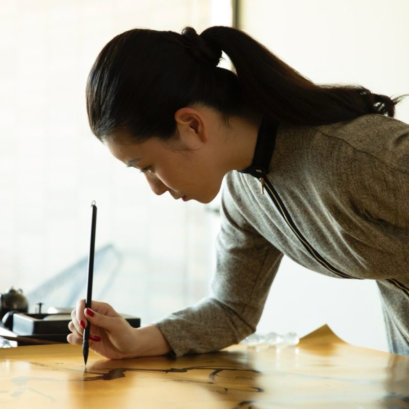 Portrait of the artist Suitou Nakatsuka at work with a brush